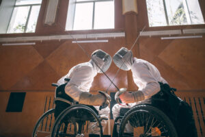 Two male disabled fencing athletes fight. men wear unbranded sports clothes