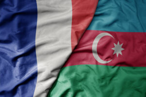 big waving realistic national colorful flag of france and national flag of azerbaijan .