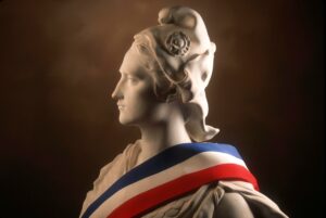 Statue of Marianne, national symbol of the French Republic draped in the French tricolour flag