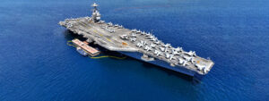 Aerial drone ultra wide panoramic photo with copy space of latest technology nuclear powered aircraft carrier USS Gerald R. Ford anchored in deep blue open ocean sea